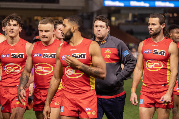 Gold Coast Suns coach Stuart Dew walks off with the playing group in what became his last match as Suns coach.