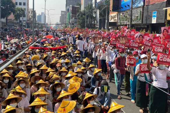 Anti-coup protesters fill the main road during a rally in Mandalay on Monday.