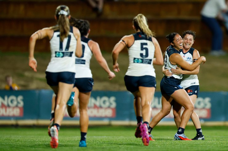 Carlton players celebrate a goal.