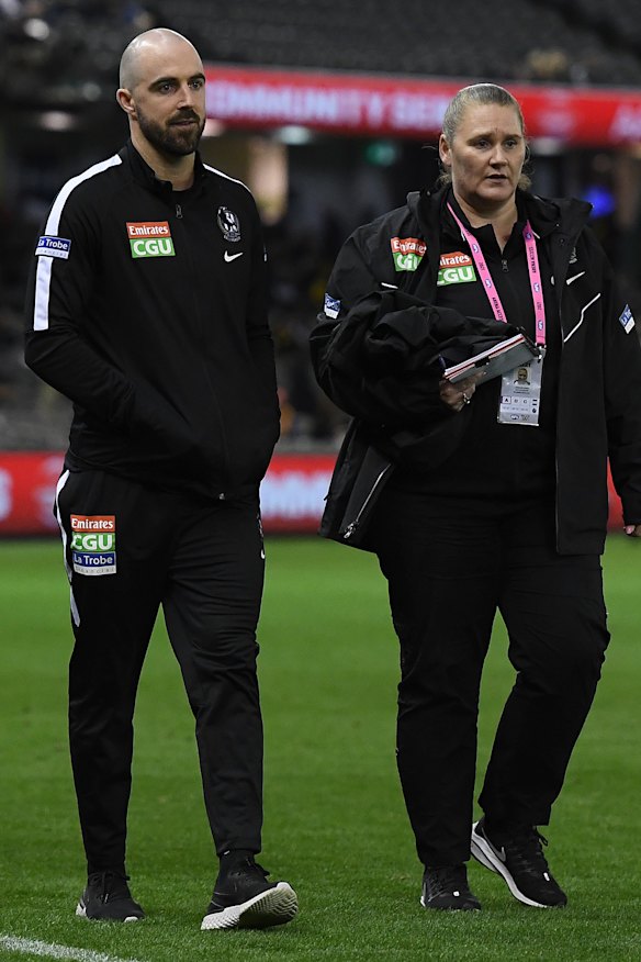Steele Sidebottom (left) walks around the boundary line on Friday night. 