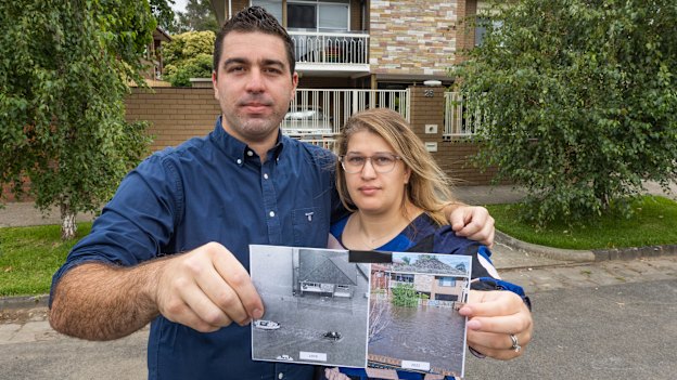 Lee and Selin Lanzafame holding up two images of their flooded home, taken 48 years apart.