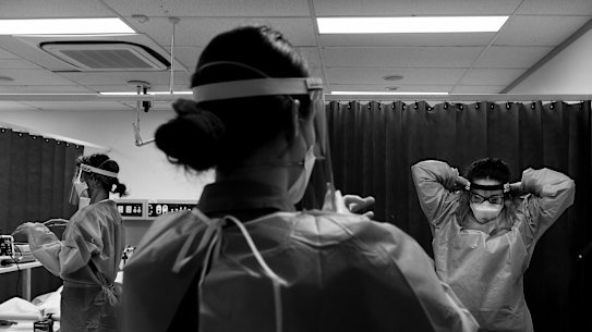  (Left to right) ICU registered nurse Sam Wylie, registered nurse on the 7 South COVID-19 ward, Tara Purtill and Sinead Forde take off their PPE in stages after completing a simulated pandemic training where the scenario is that a COVID-19 patient goes into cardiac arrest at St Vincent’s Hospital, Darlinghurst. 