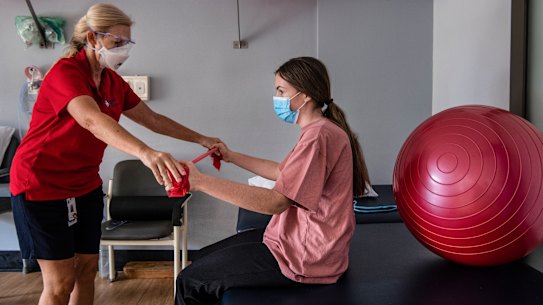 A patient works with a physiotherapist at NSW’s first long-COVID clinic.