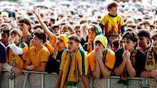 Socceroos fans watch them play Paraguay at the Tumbalong Park live site in Sydney.