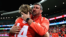 Callum Mills and Dean Cox embrace.
