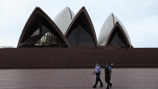 Police patrol around the Sydney Opera House as mask wearing outside became mandatory across NSW during a covid-19 lockdown in Sydney on August 23, 2021