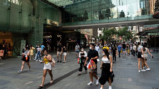 People attend the Boxing day sales in Sydney’s CBD despite NSW recording 6394 COVID-19 cases.