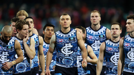Patrick Cripps leads the Blues off the field after the loss against Sydney.