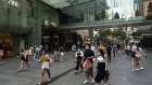 People attend the Boxing day sales in Sydney’s CBD despite climbing COVID-19 cases.