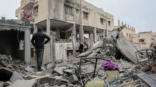 People inspecting the damage and recovering items from their homes following Israeli air strikes in Rafah.