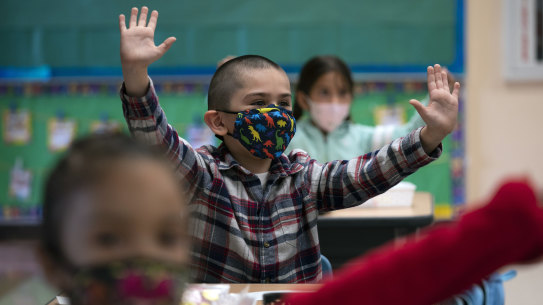 Children in a Los Angeles elementary school wear masks in April. Similar scenes await Victorian classrooms later this month.