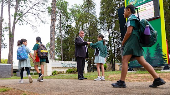 Warrigal Road State School Principal Andrew Duncan greets students at the school gates. 