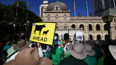 Farmers and their supporters protest outside Parliament House in Brisbane on Tuesday.