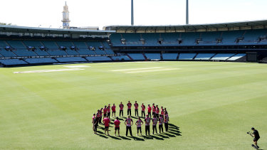 The Sydney Sixers take part in a barefoot circle ahead of their game at the SCG on Saturday.