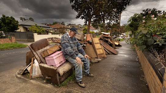 Brian Matthews with flood-ruined contents of his Maribyrnong house.