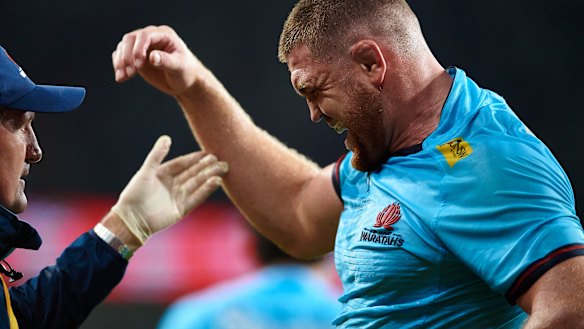 Swinton receives medical attention after being injured in the round one match against the Drua last year.