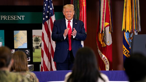 President Donald Trump claps after delivering a speech about the US anti-narcotics operations in Doral, Florida.
