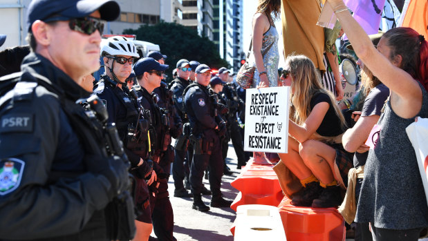 Police and protesters face-off in the Brisbane CBD.