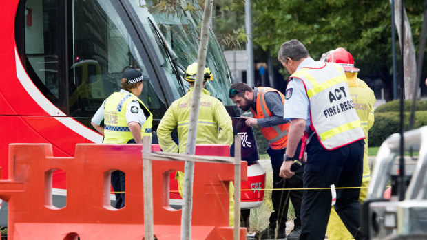 Emergency services at the scene of a collision between a tram and a pedestrian in Canberra on Saturday morning.