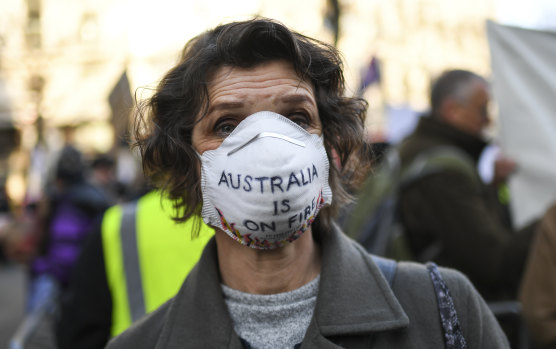 A climate change protester outside Australia's embassy in London early this year as the bushfires raged and the coronavirus crisis was just beginning to unfold.