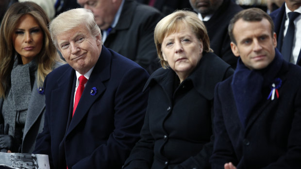 US President Donald Trump, German Chancellor Angela Merkel and French President Emmanuel Macron attend ceremonies at the Arc de Triomphe on Sunday.

