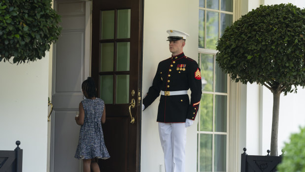 “Extraordinary courage”: A Marine holds the door as Gianna Floyd, the daughter of George Floyd, walks into the White House.