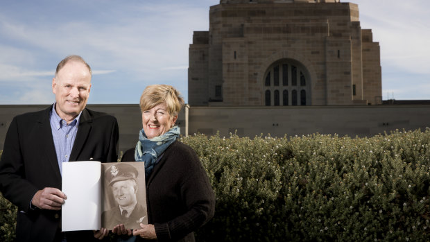 Peter and Sue Willis outside the Australian War Memorial with a picture of their late father Ken, who has been awarded France's highest military honour.