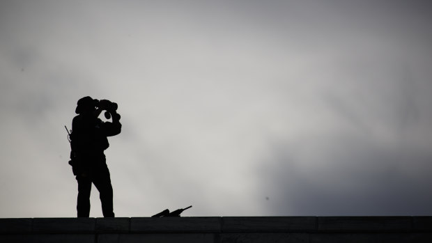 Security stands on the roof of the United Nations building during a visit by President Donald Trump.
