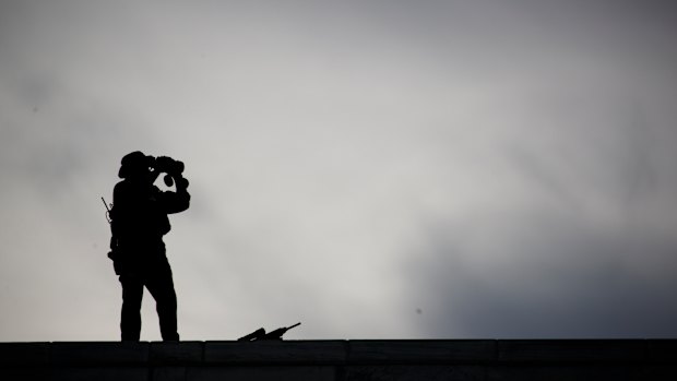 Security stands on the roof of the United Nations building during a visit by President Donald Trump.