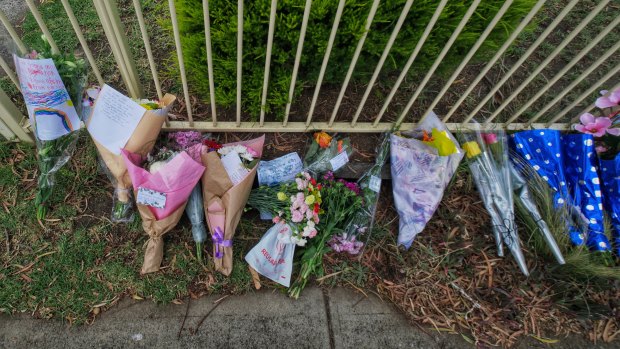 Flowers and cards  in front of the Tullamarine house where  42-year-old Katie Perinovic, and her three children - Claire, 7, Anna,5, and Matthew, 3, were found dead.
