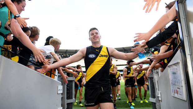 Jack Higgins celebrates with fans after his attention-grabbing debut for Richmond.