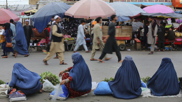 Women selling vegetables wait for customers at a market in Kabul, Afghanistan.