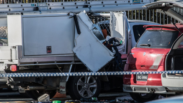 A damaged ute in the car park at St Clare of Assisi Primary School in Conder on Friday, the day after a fatal explosion blamed on a leaking gas bottle.