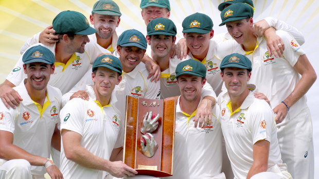 Long wait: Australia's captain Tim Paine holds the trophy as he poses with teammates after they finally broke through for a series victory.