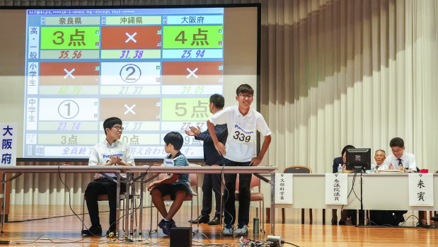 A member of a team from Osaka takes a bow after scoring 5 points at the abacus championships in Kyoto
