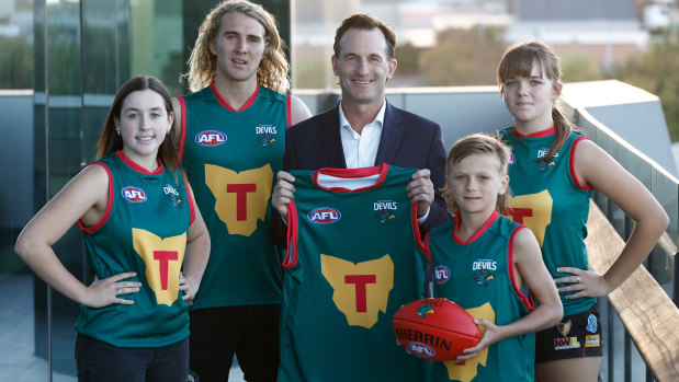 AFL chief Andrew Dillon with players to launch the Tasmanian Devils football club.