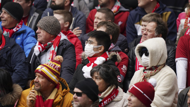 Fans wearing face masks attend a Liverpool match in the English Premier League on March 7.