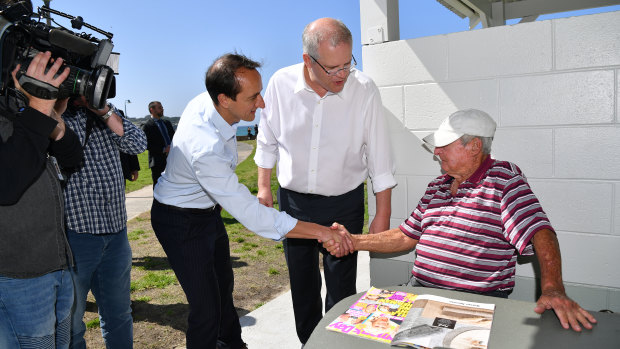 Prime Minister Scott Morrison and Liberal Party candidate for Wentworth Dave Sharma chat with Les O'Keefe during a visit to Bronte Beach in Sydney,