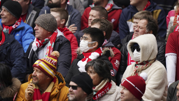 Fans wearing face masks attend a Liverpool match in the English Premier League.