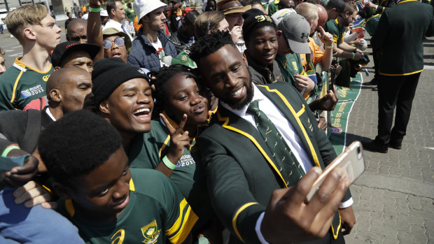Inspiration: Siya Kolisi takes a selfie with fans before the Springboks left South Africa for the World Cup.
