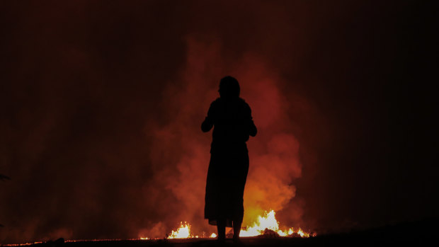 Stefani Hinkle watches lava erupt inside Leilani Estates near Pahoa, Hawaii. 