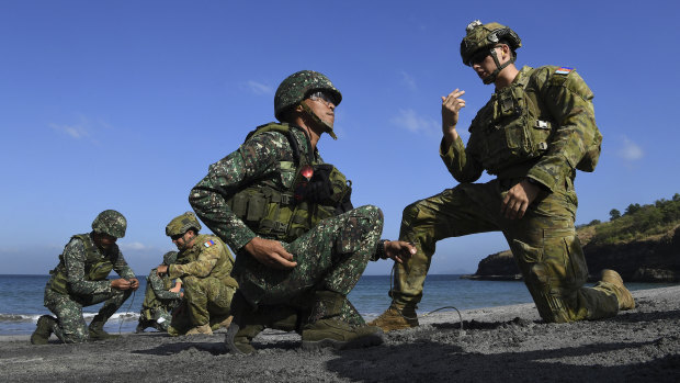 Australian Army Sapper Nicholas Field (right) and Lance Corporal Callum Leete (second from left) instruct members of the Philippines military. 