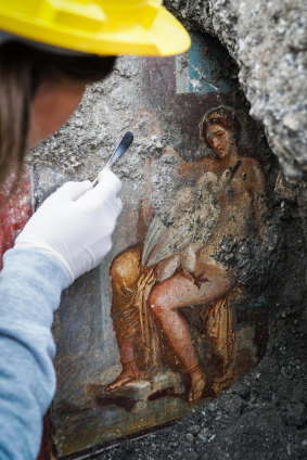 An archaeologist cleans up the fresco ''Leda e il cigno'' (Leda and the swan) discovered last Friday in the Regio V archeological area in Pompeii.