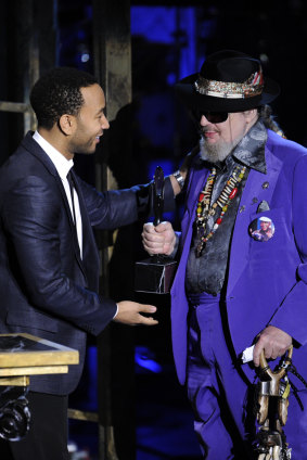 Dr. John, right, is presented his trophy by John Legend at the Rock and Roll Hall of Fame induction ceremony in New York. 