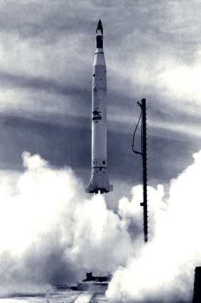 Lift-off … The satellite-topped Redstone rocket is caught at the moment of blast-off by a remote control camera near the launch pad at Woomera.