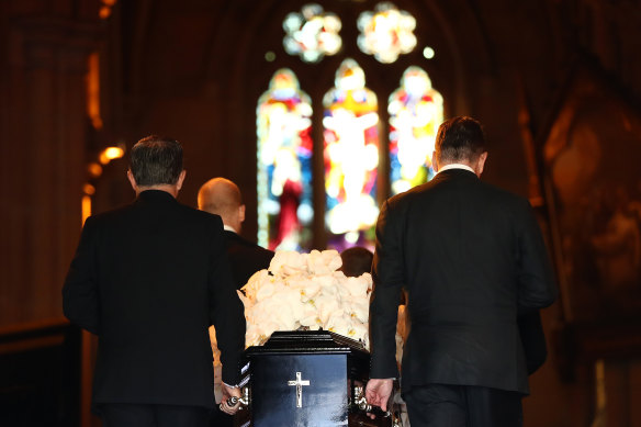 Pallbearers carry the casket of Carla Zampatti into St Mary’s Cathedral