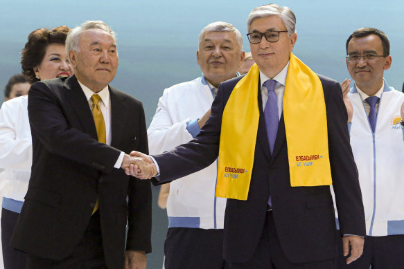 Factions: Then-acting President Kassym-Jomart Tokayev, right, and former Kazakh President Nursultan Nazarbayev shake hands in 2019. 