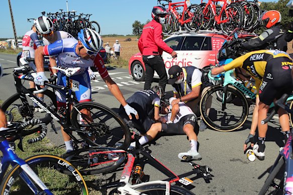 Nicolas Roche, centre, is treated by medics after falling during the tenth stage of the Tour de France. 