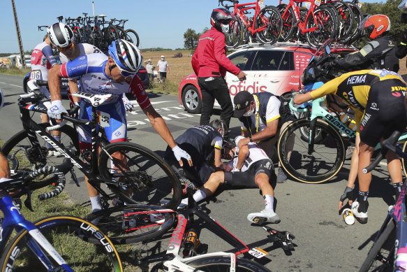 Nicolas Roche, centre, is treated by medics after falling during the tenth stage of the Tour de France. 