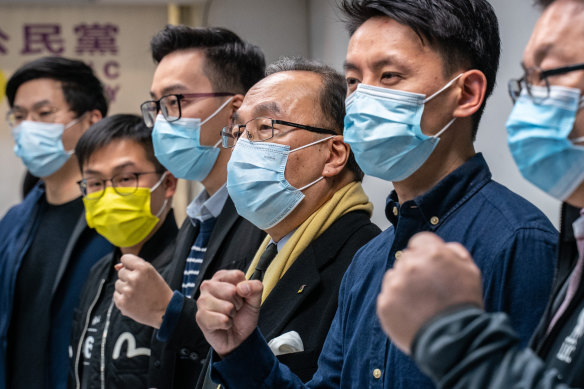 Pro-democracy activists gesture during a press conference on January 6 in Hong Kong after 50 opposition figures were arrested under the national security law.